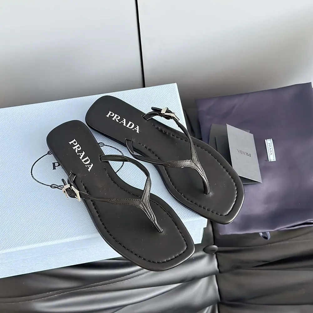 Top-down angle of Prada Women Leather Thong Sandals-Black on white background
