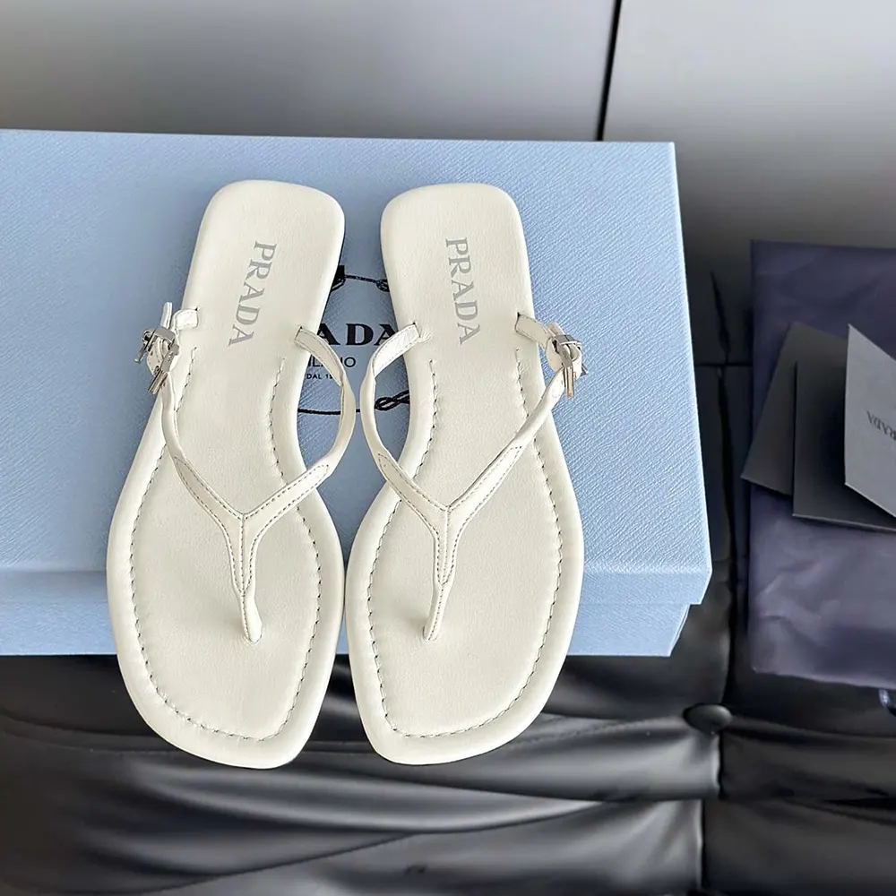 Side angle of Prada Women Leather Thong Sandals-White highlighting leather texture