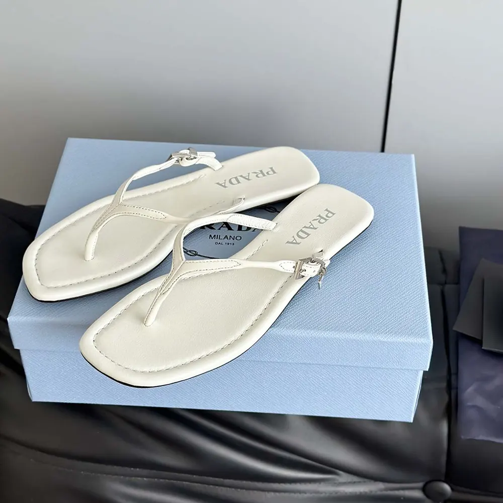 Close-up of sole and embossed Prada logo on Prada Women Leather Thong Sandals-White