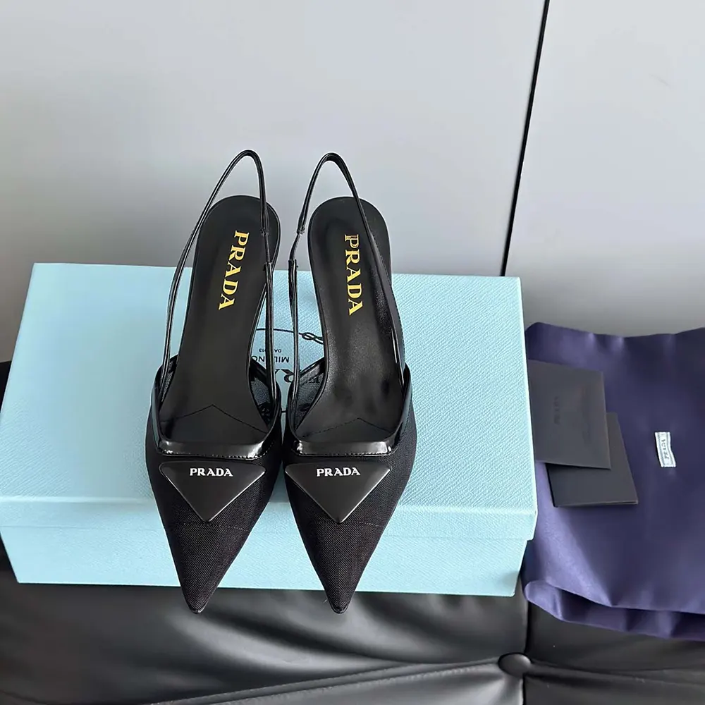 Close-up of black mesh fabric and Prada hardware on slingback pumps