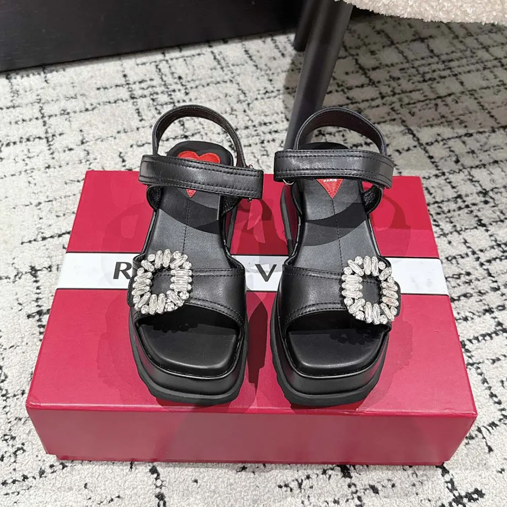 Close-up of signature buckle on Roger Vivier Women Slidy Viv’ Wedge Sandals