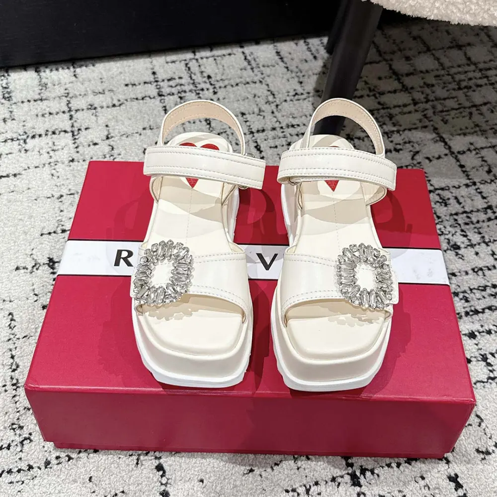 Close-up of signature buckle on Roger Vivier Women Slidy Viv’ Wedge Sandals
