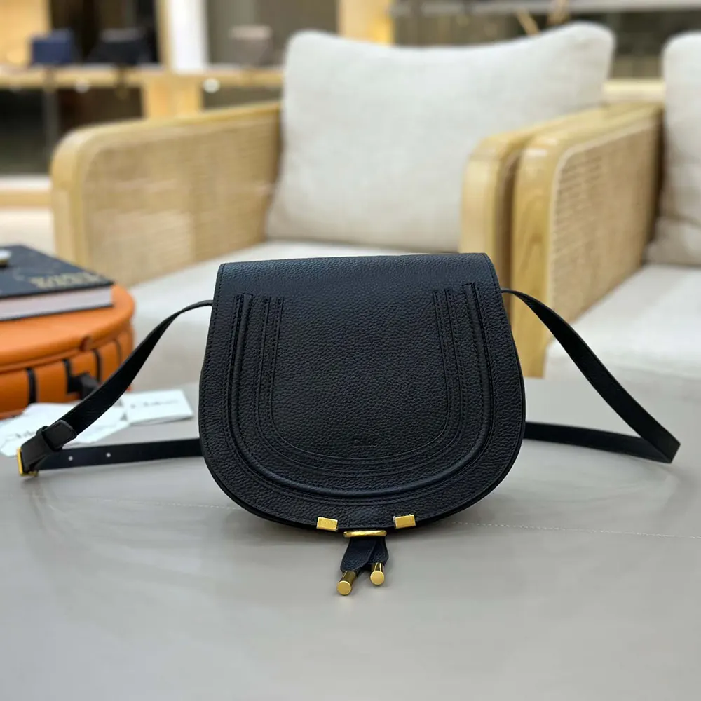Close-up of magnetic flap closure on Marcie Saddle Bag by Chloé
