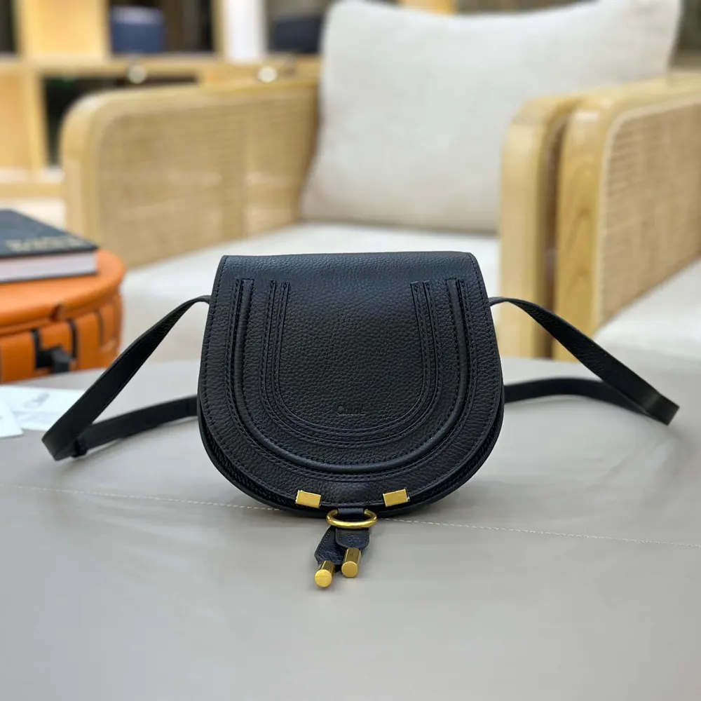 Close-up of gold-tone hardware on Chloe Women Small Marcie Saddle Bag