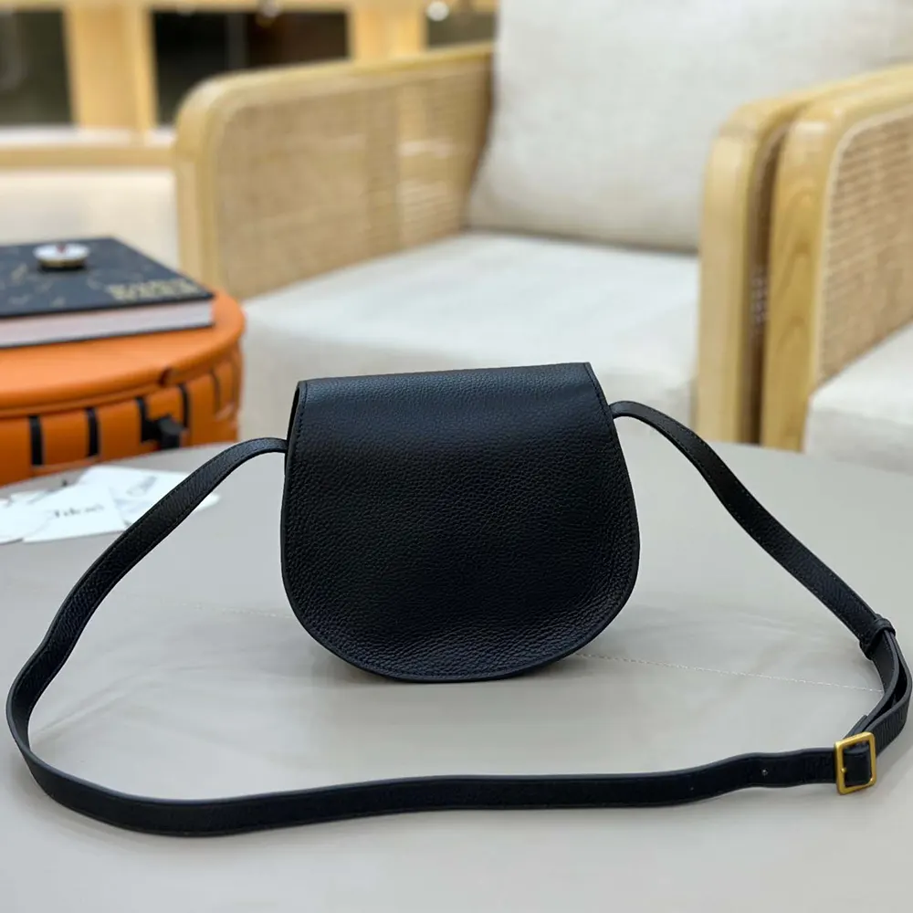 Side profile showing curved silhouette of Chloe Women Small Marcie Saddle Bag
