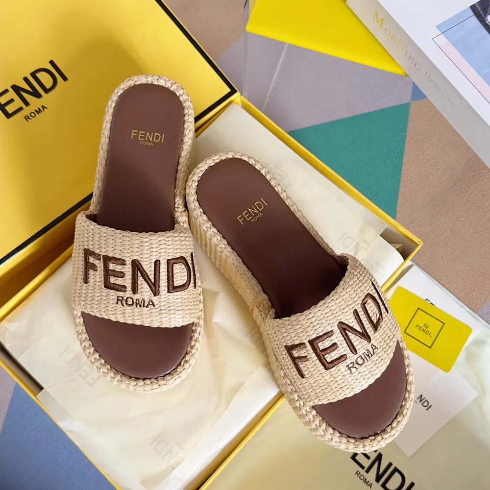 Close-up on gold-tone Fendi hardware on raffia flatform slides