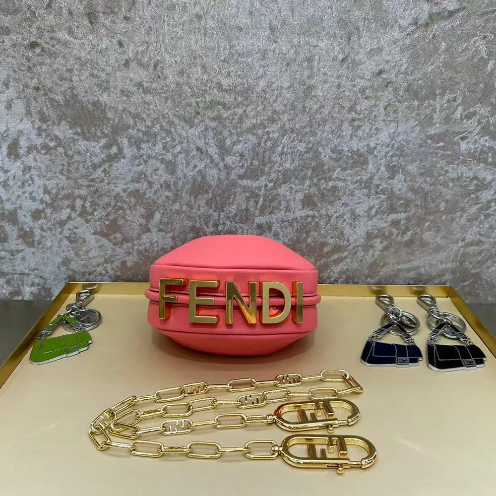 Side angle showing pink leather texture and shoulder strap of Fendi Nano Charm