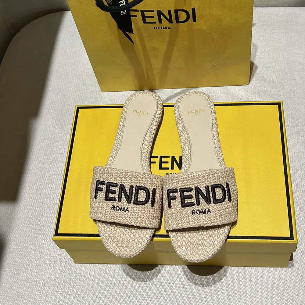 Close-up of Fendi logo embossed detail on beige cotton fiber slide