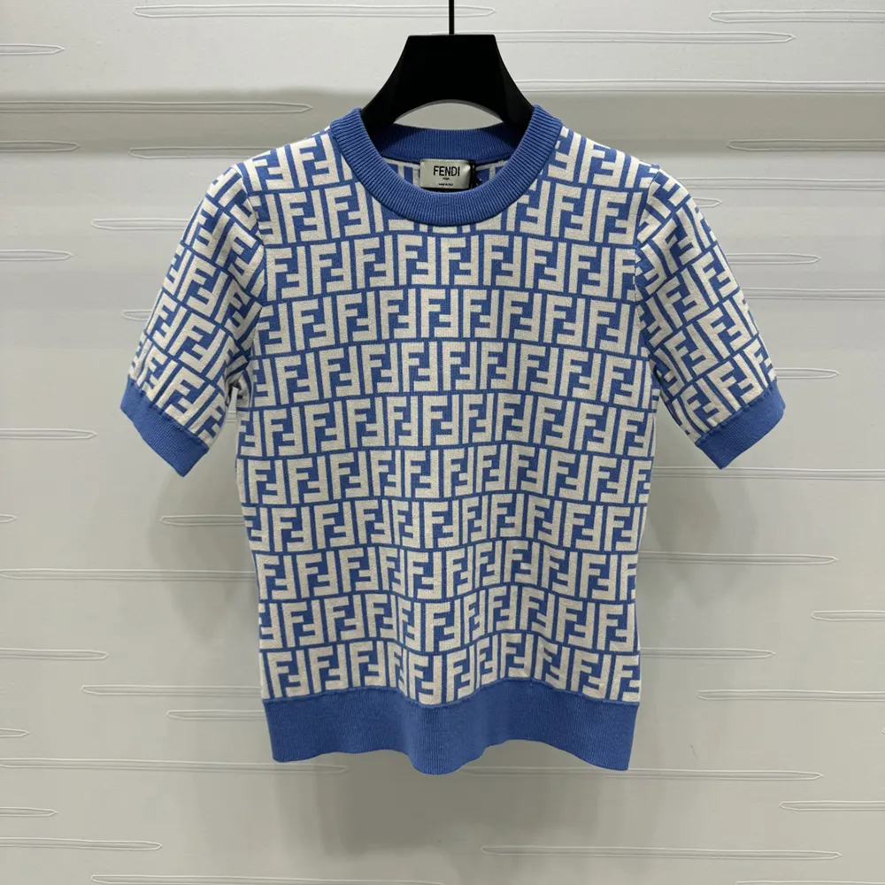 Close-up of blue cotton fabric and tonal FF embroidery on jumper