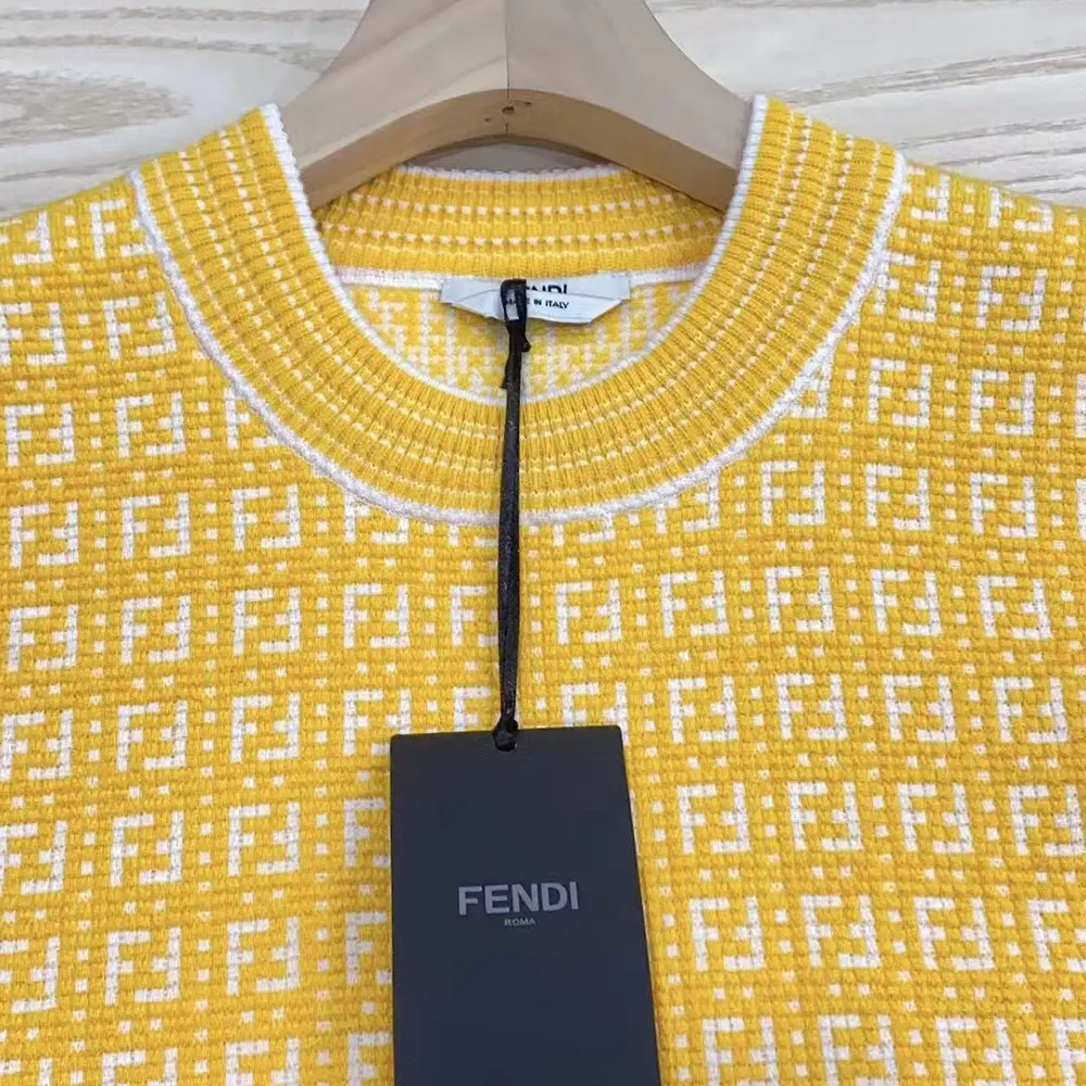 Side angle showing ribbed cuffs and hem of Fendi cotton jumper
