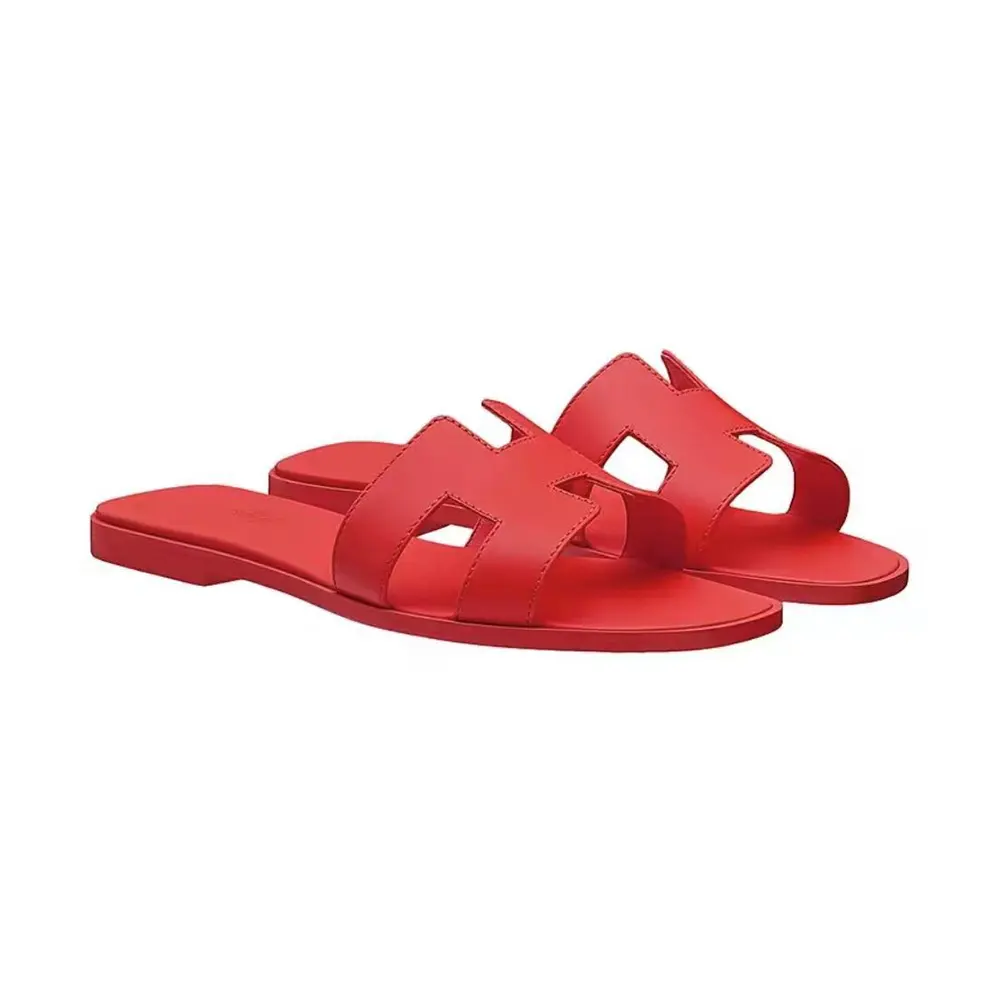Side angle of Hermes Women Oran Sandal-Red showcasing signature H-cut