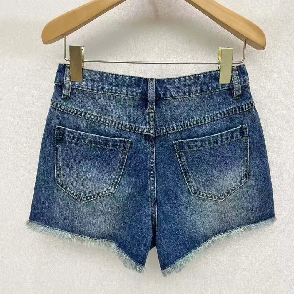 Close-up of signature Anagram embroidery on Loewe Women Anagram Shorts in Denim