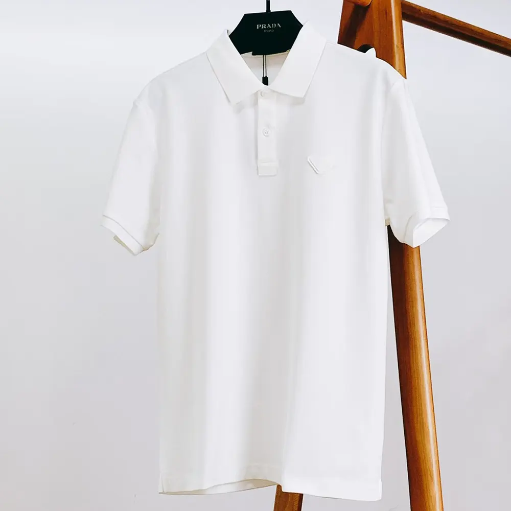 Close-up of Prada triangle logo on white Men Piqué Polo Shirt