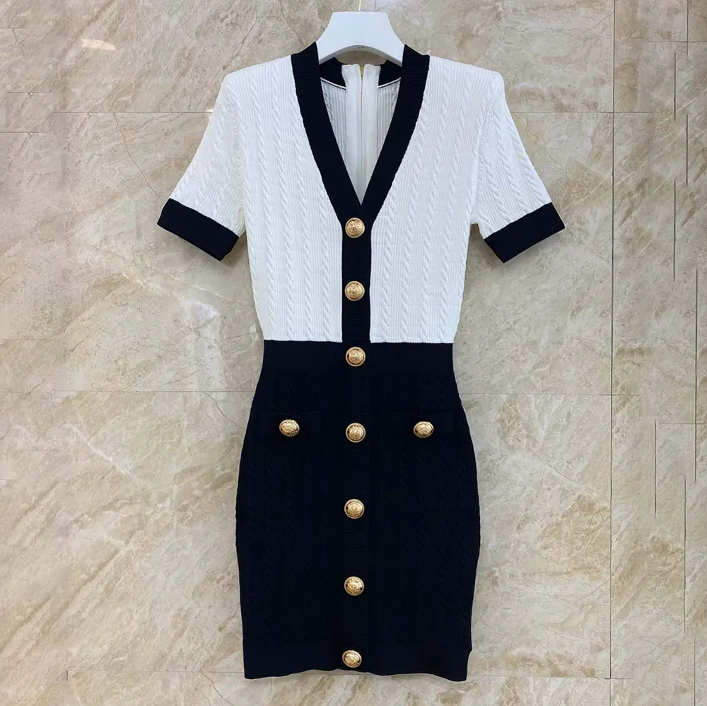 Close-up of cable-knit texture and Balmain hardware on black dress