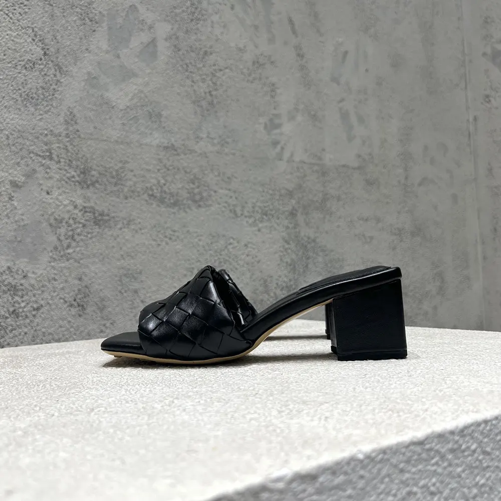 Close-up of black leather and signature weave on Bottega Veneta mule