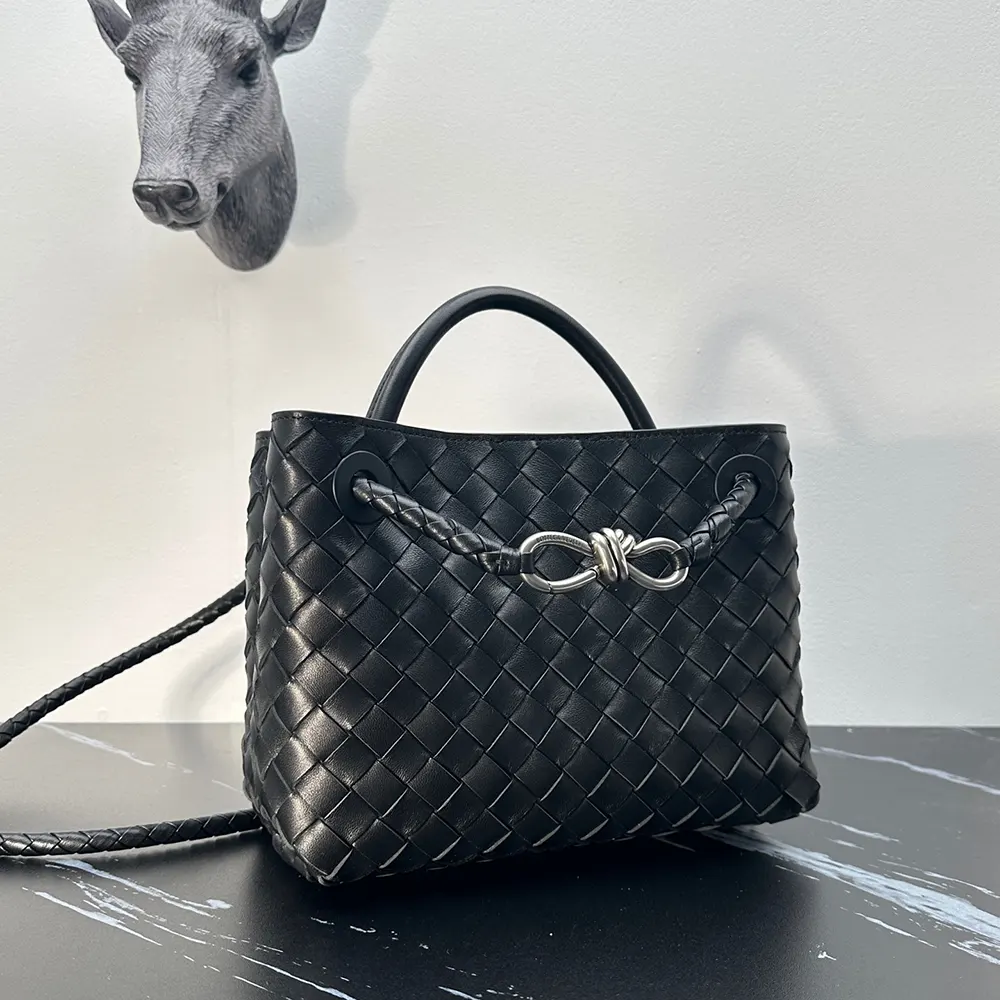 Side profile showing compact silhouette and top handle of Bottega Veneta Small Andiamo bag