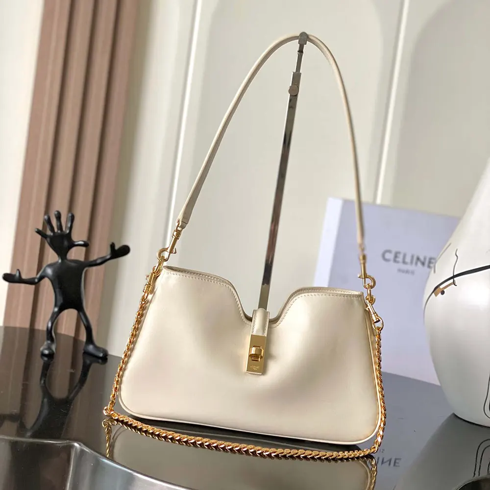 Close-up of smooth white calfskin and gold hardware on Celine Camille 16