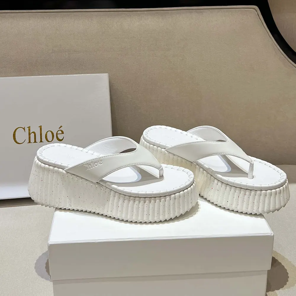 Top angle of Chloe Women Nama Wedge Slide-White highlighting smooth leather