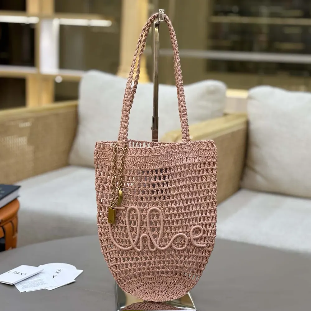 Close-up of gold hardware and pink leather trim detail on Chloe tote