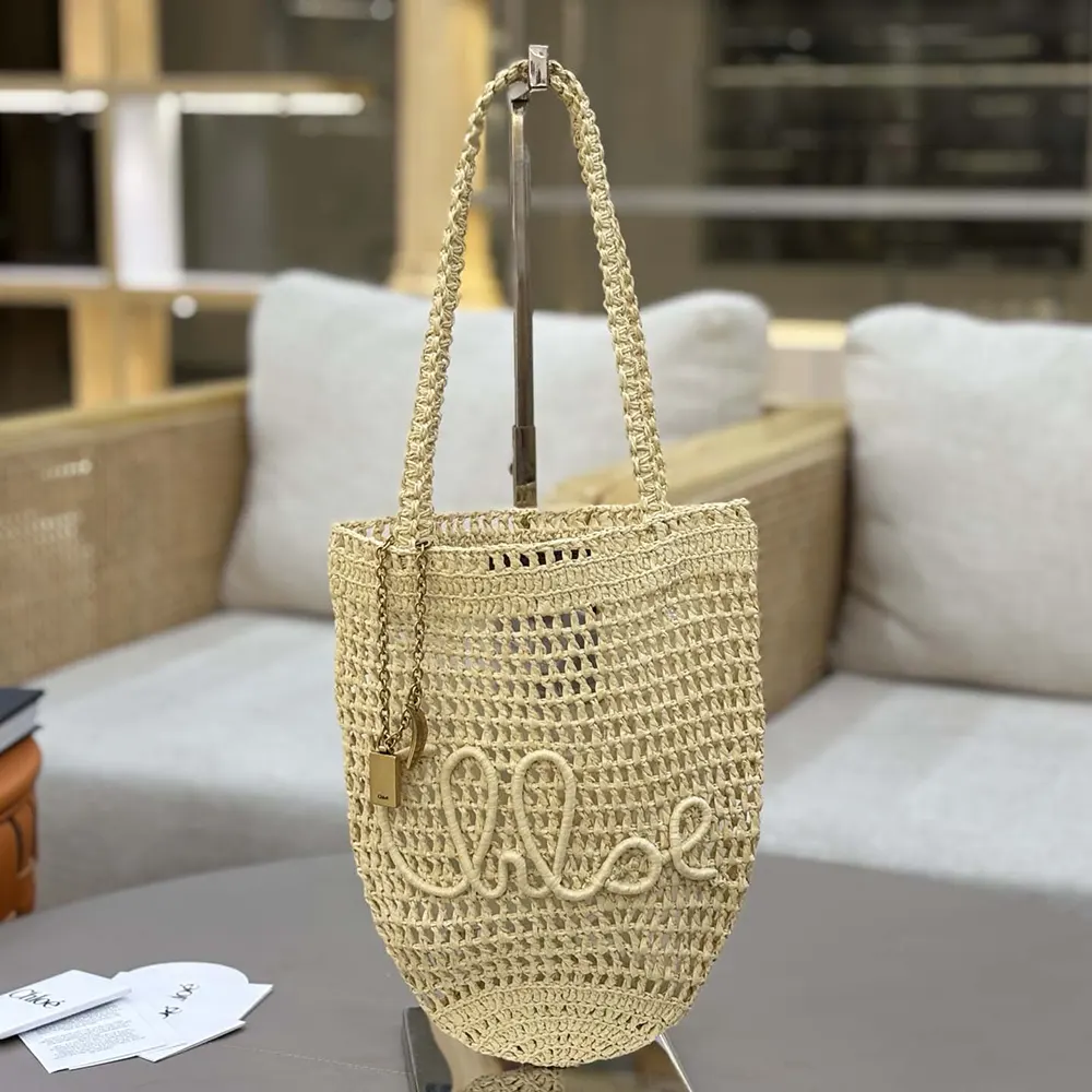 Side angle showing leather trim and tote handle of Chloe Small Summer Banana Tote