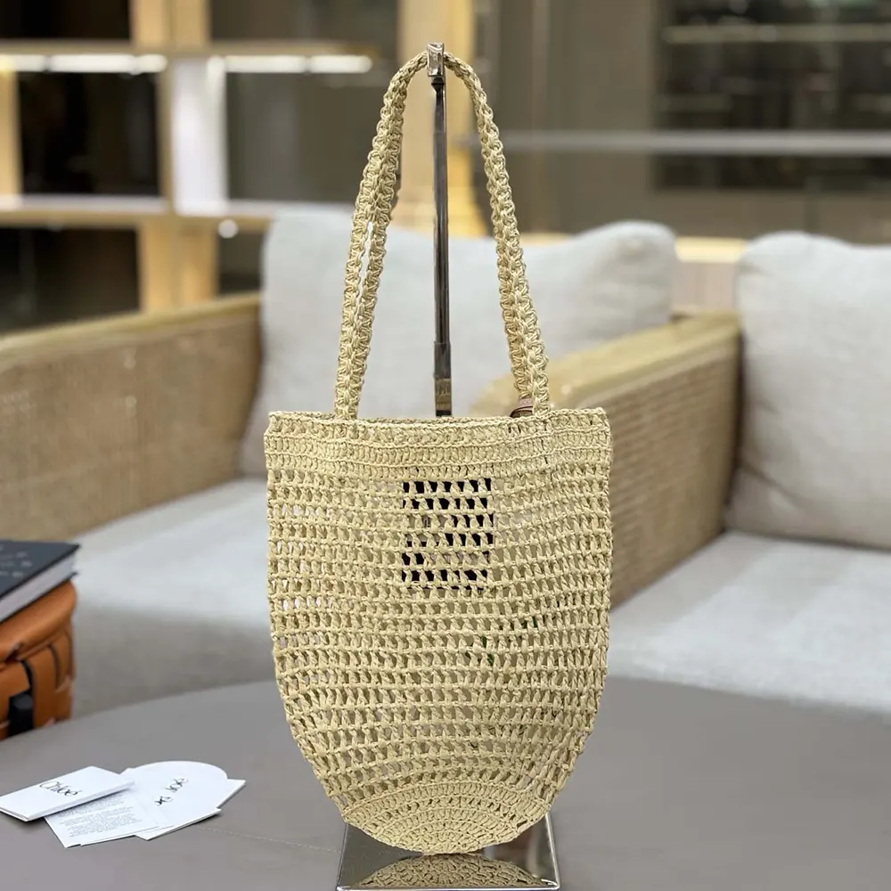 Close-up detail of raffia weave and gold hardware on Chloe tote bag