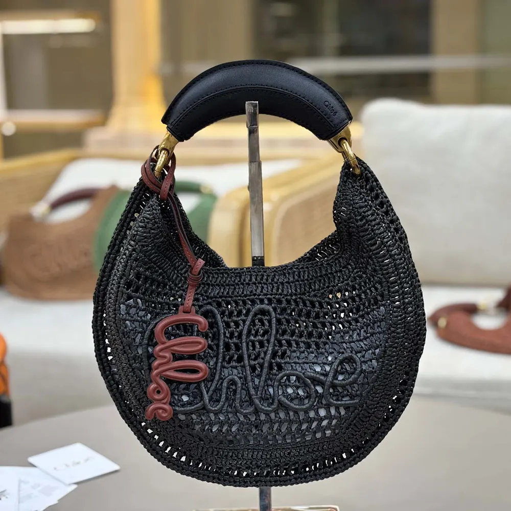 Close-up of gold hardware on Chloe Women Summer Banana Hobo Bag In Raffia-Black