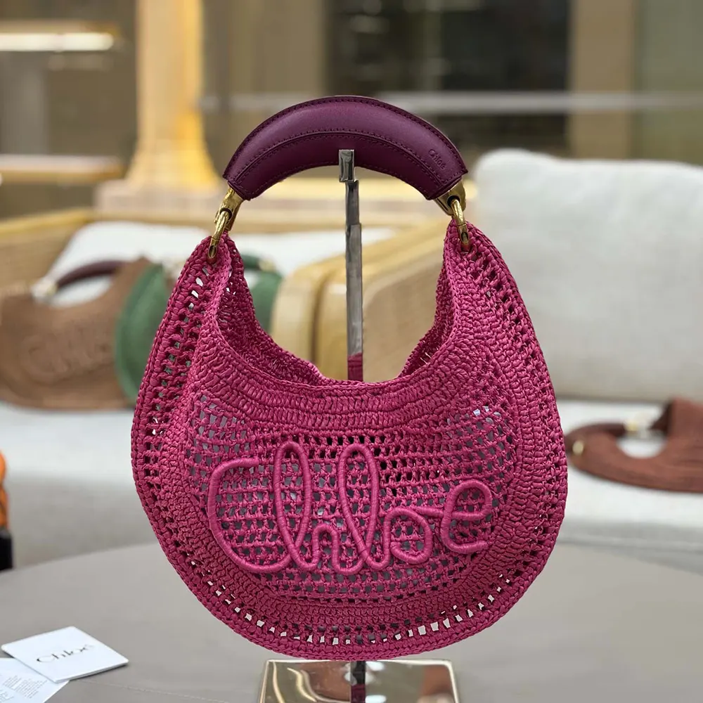 Close-up of gold hardware and rose leather trim on Chloe Summer Banana Hobo Bag
