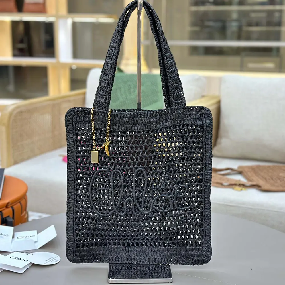 Close-up of black leather trim and gold hardware on Chloe tote bag