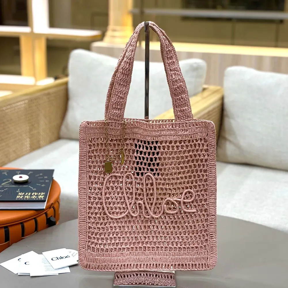 Close-up detail of gold-tone hardware on Chloe Women Summer Banana Tote Bag In Raffia-Pink