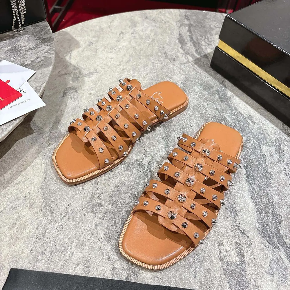 Overhead shot highlighting red sole on Christian Louboutin Charja Women’s mules