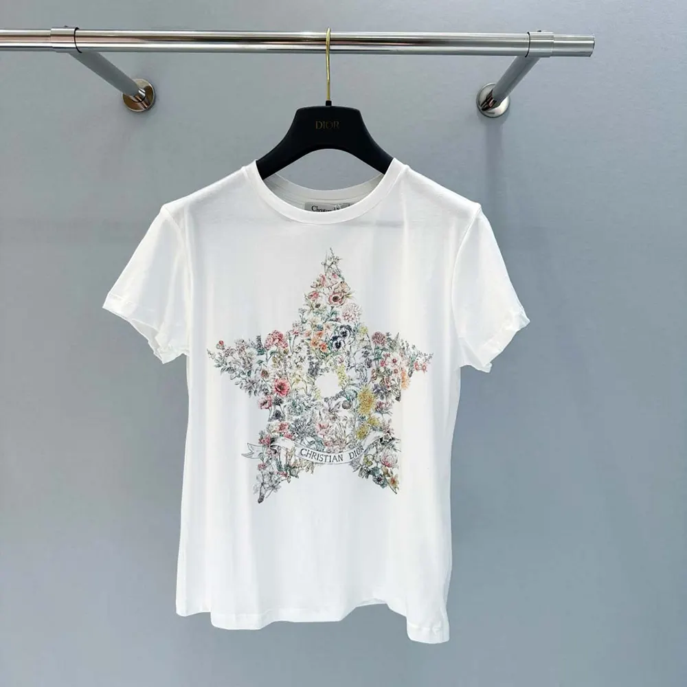 Close-up of multicolor Dior star motif on white cotton-linen T-shirt