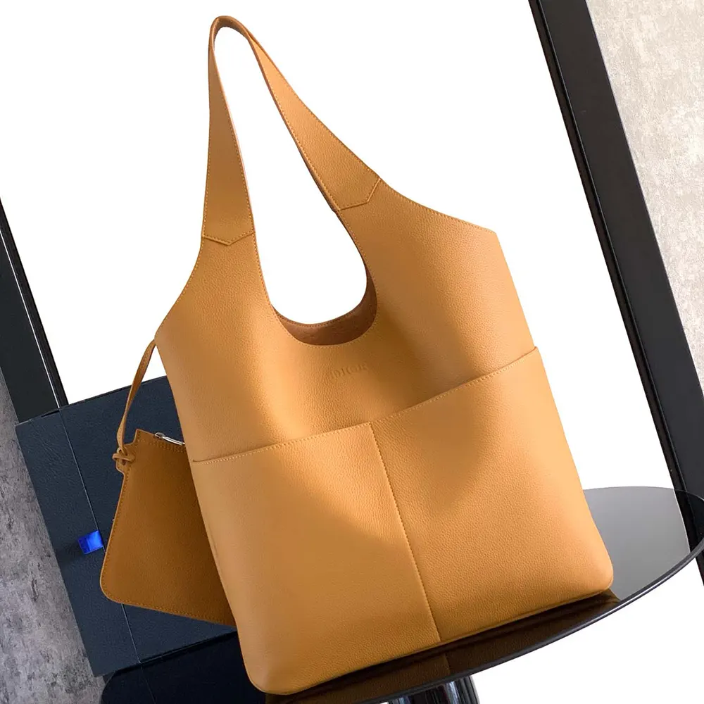 Close-up of Dior Icons hardware on brown calfskin tote bag
