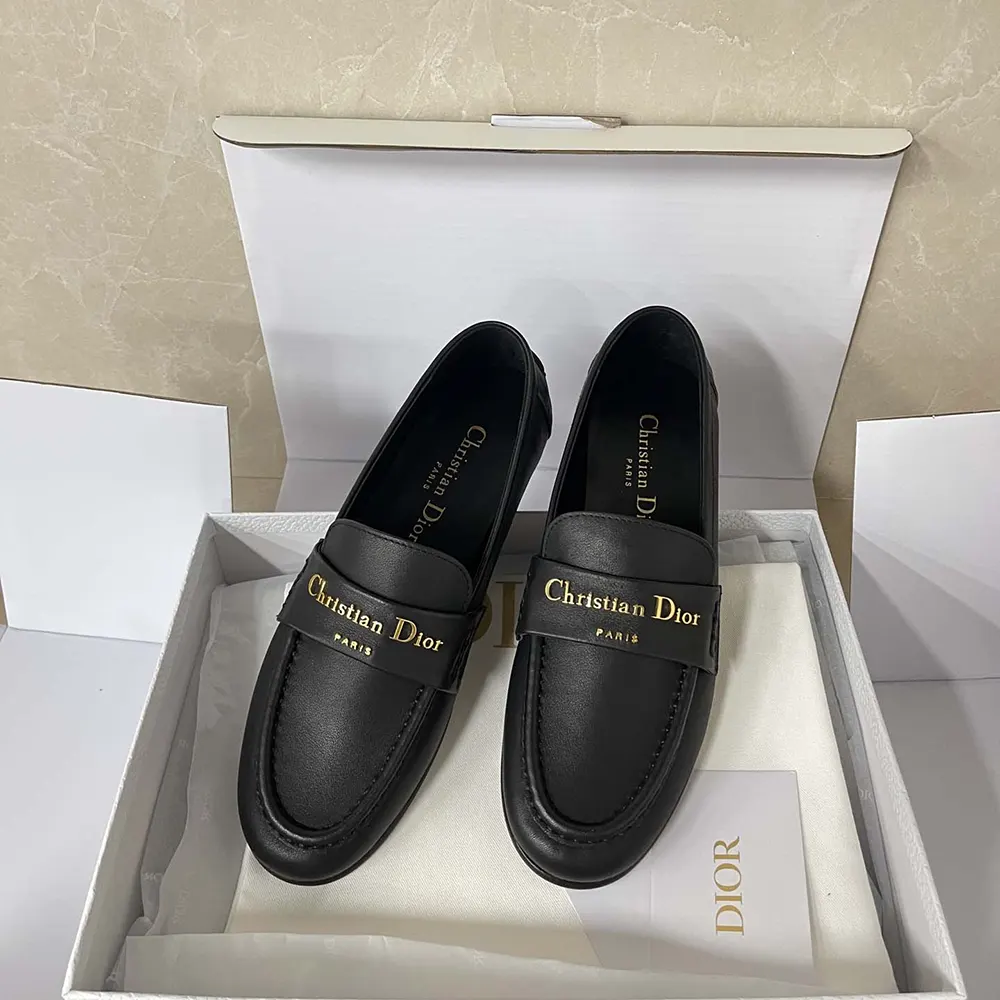 Close-up of silver-tone Dior hardware on black calfskin loafer