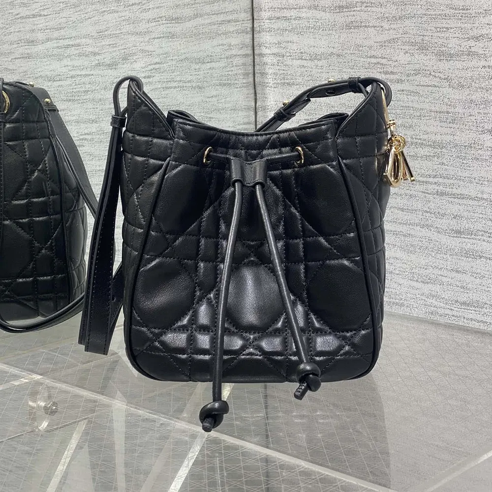 Close-up of silver ‘D’ charm on Dior Women Small D-Motion Bag