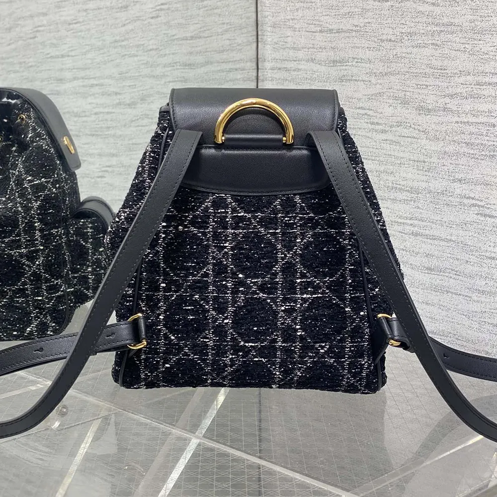Side angle showing silver hardware on Dior Women Medium Dior Caro Backpack Black Tweed