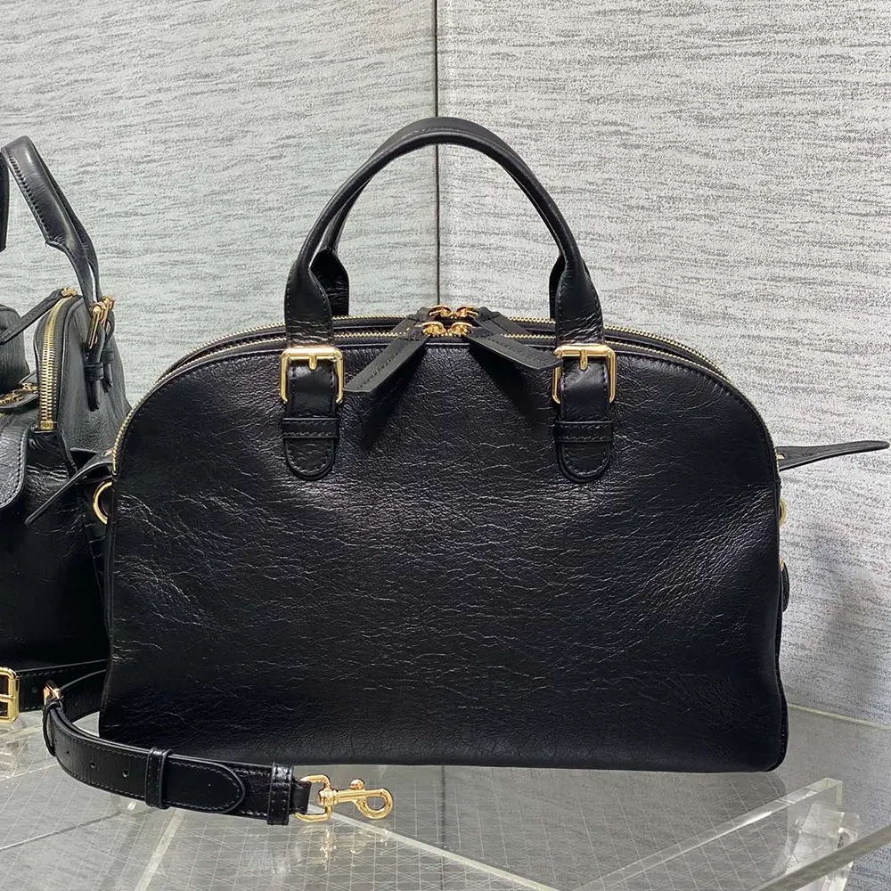 Side view showcasing silver hardware on Dior Women Medium Grand Tour Bowling Bag