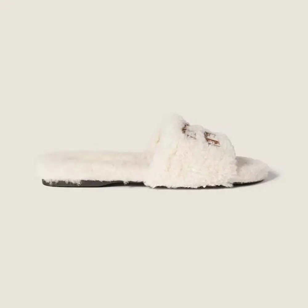 Side view of Miu Miu Women Shearling Slides with Leather Logo in white