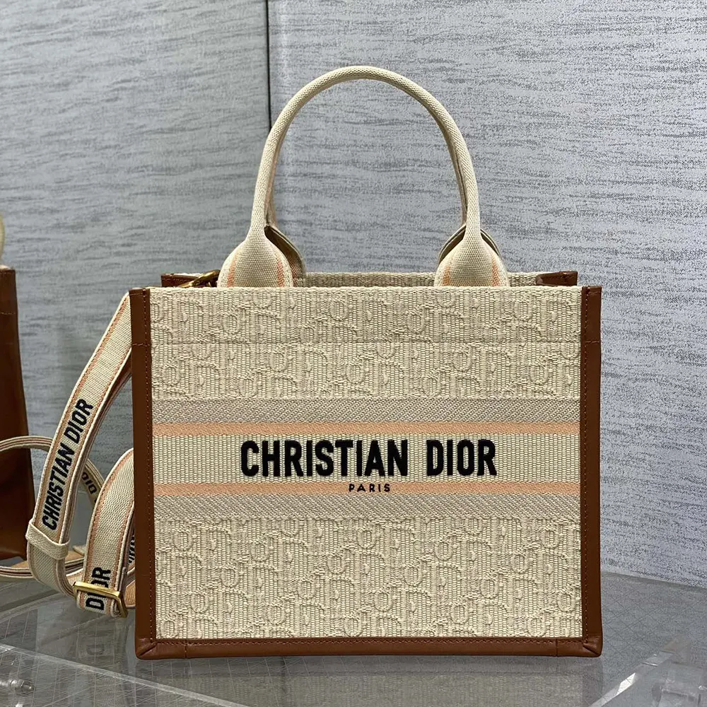 Close-up detail of embroidered raffia and camel calfskin on Dior Small Dior Book Tote