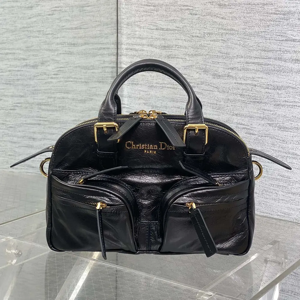 Side angle showing adjustable strap on Dior Women Small Grand Tour Bowling Bag