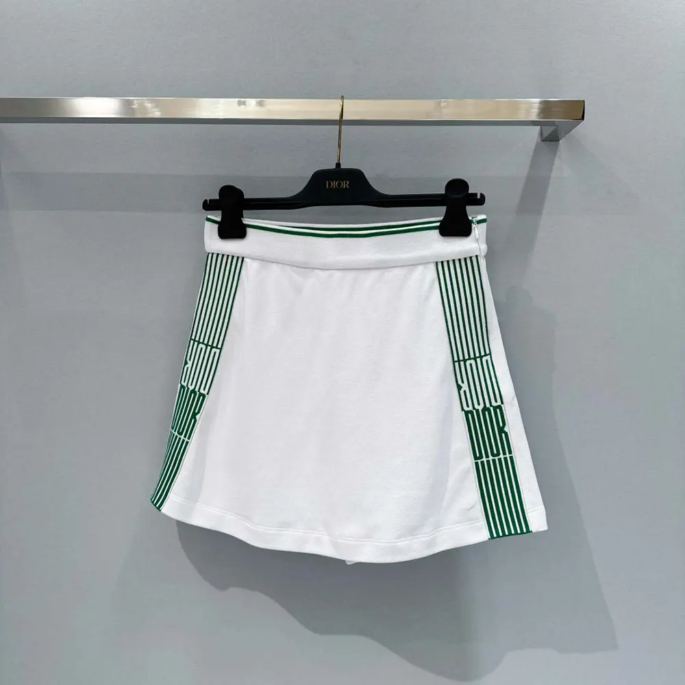 Close-up of pine green Dior graphique motif on white cotton jersey skort