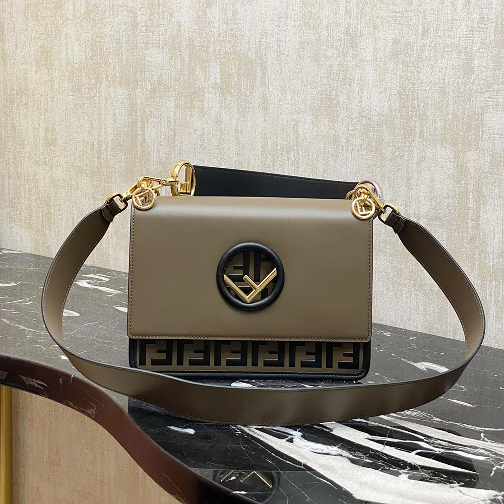 Side angle showing adjustable shoulder strap of Fendi gray mini-bag