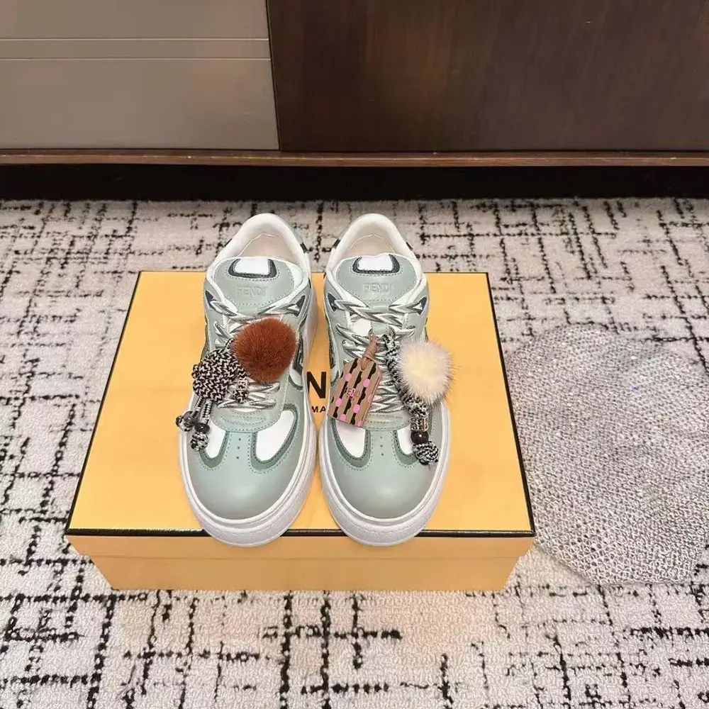 Close-up of gold-tone charm on Fendi Women Match Low Top Platform Shoes