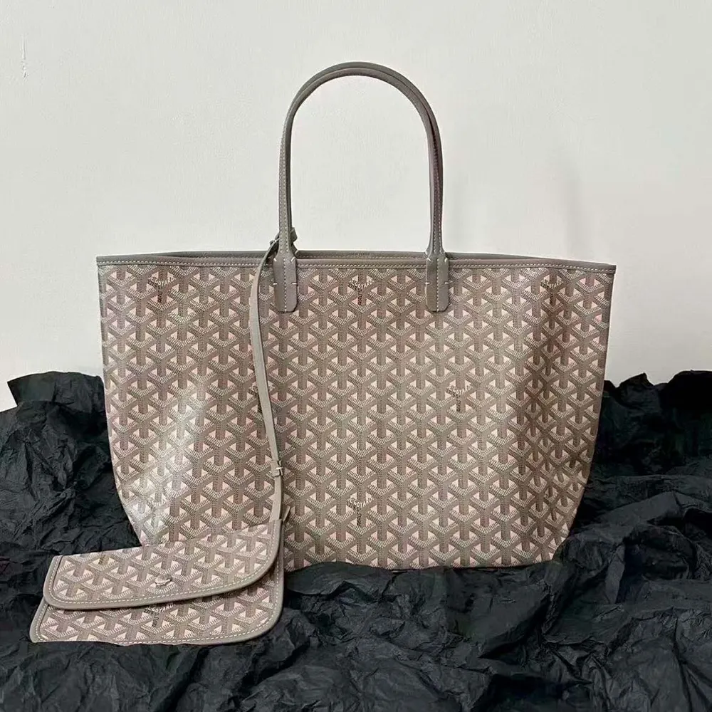 Close-up of gold-tone hardware and pink accent on Goyard Saint Louis GM Bag