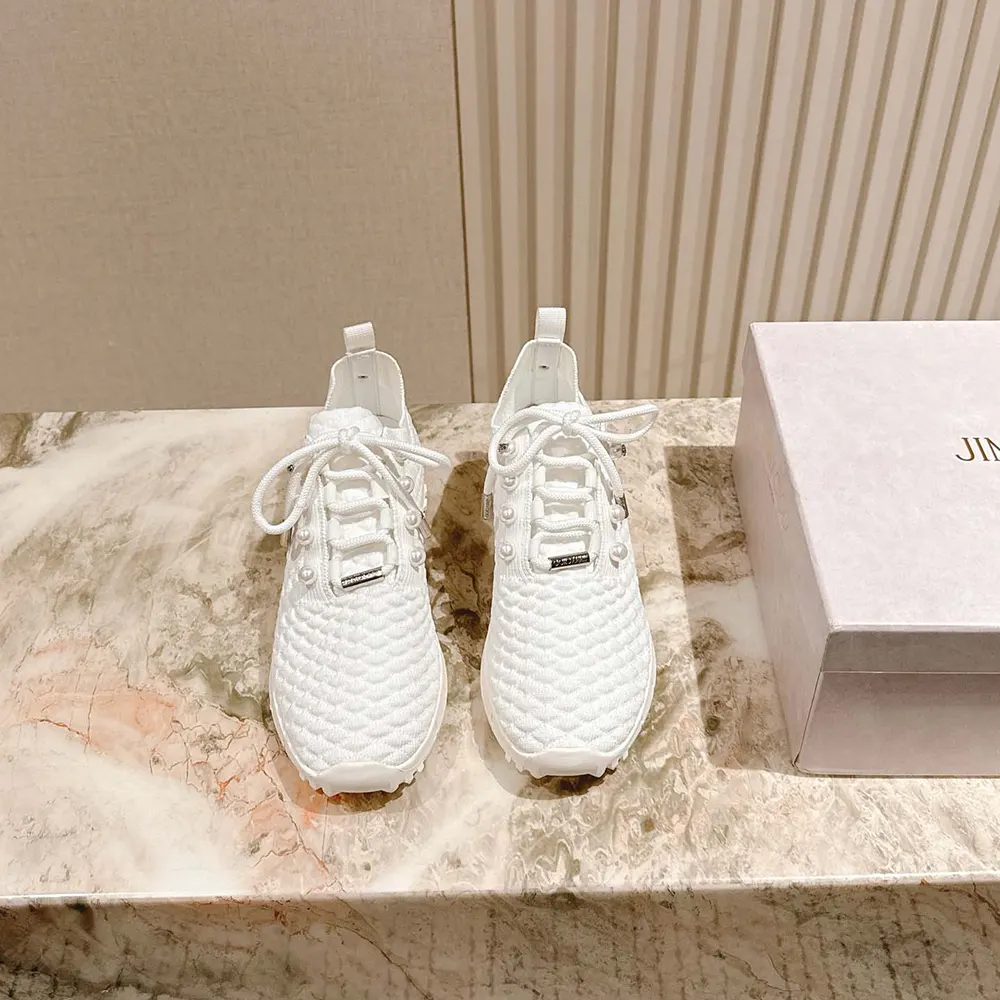 Close-up of textured knit and metal logo on Jimmy Choo trainers