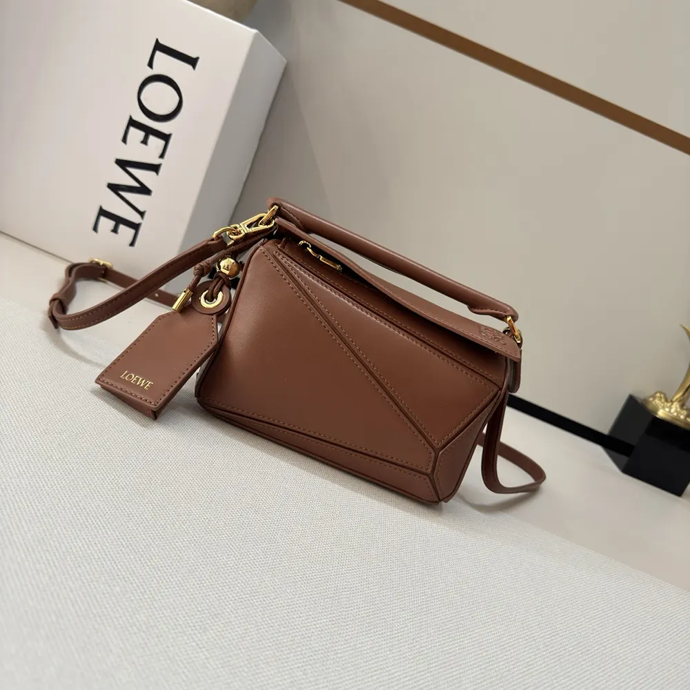 Close-up detail of leather texture and gold hardware on Loewe Puzzle Bag