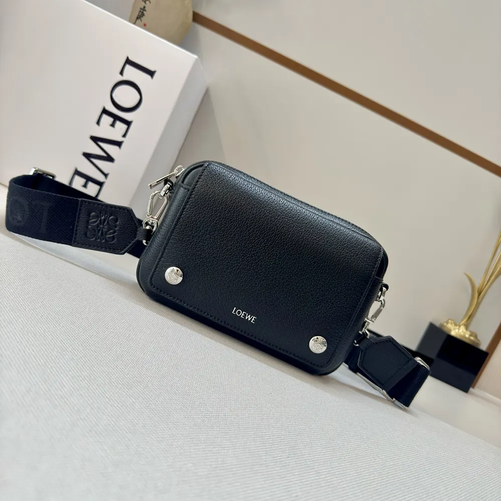 Close-up of grained calfskin texture and brushed metal hardware on Loewe bag