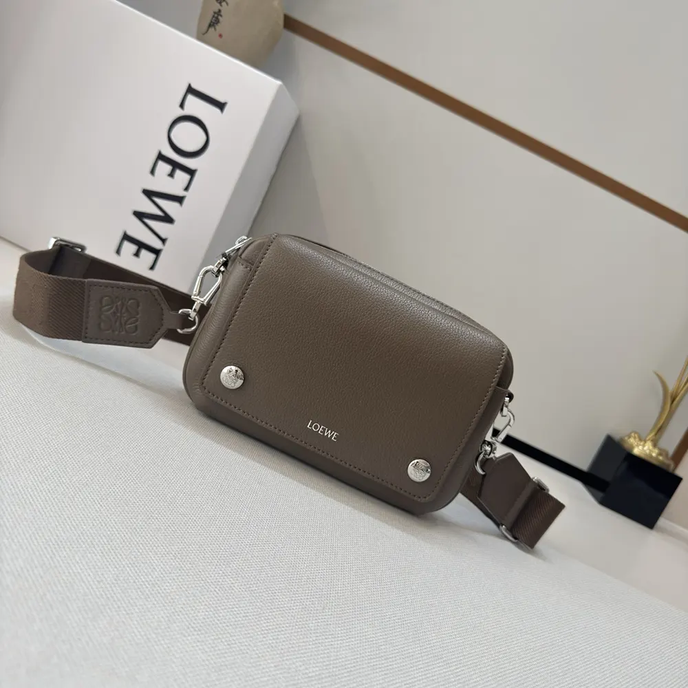 Close-up of pebble-grained leather texture on Loewe small messenger bag