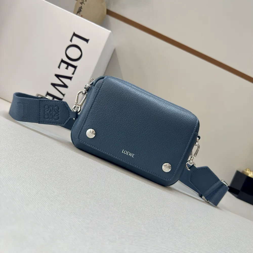 Close-up of magnetic flap and silver hardware on Loewe Pebble Messenger Bag