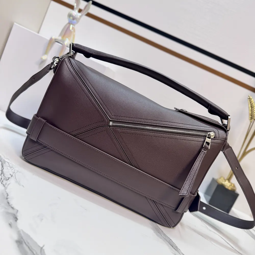 Side view showing adjustable shoulder strap and silver-tone zipper