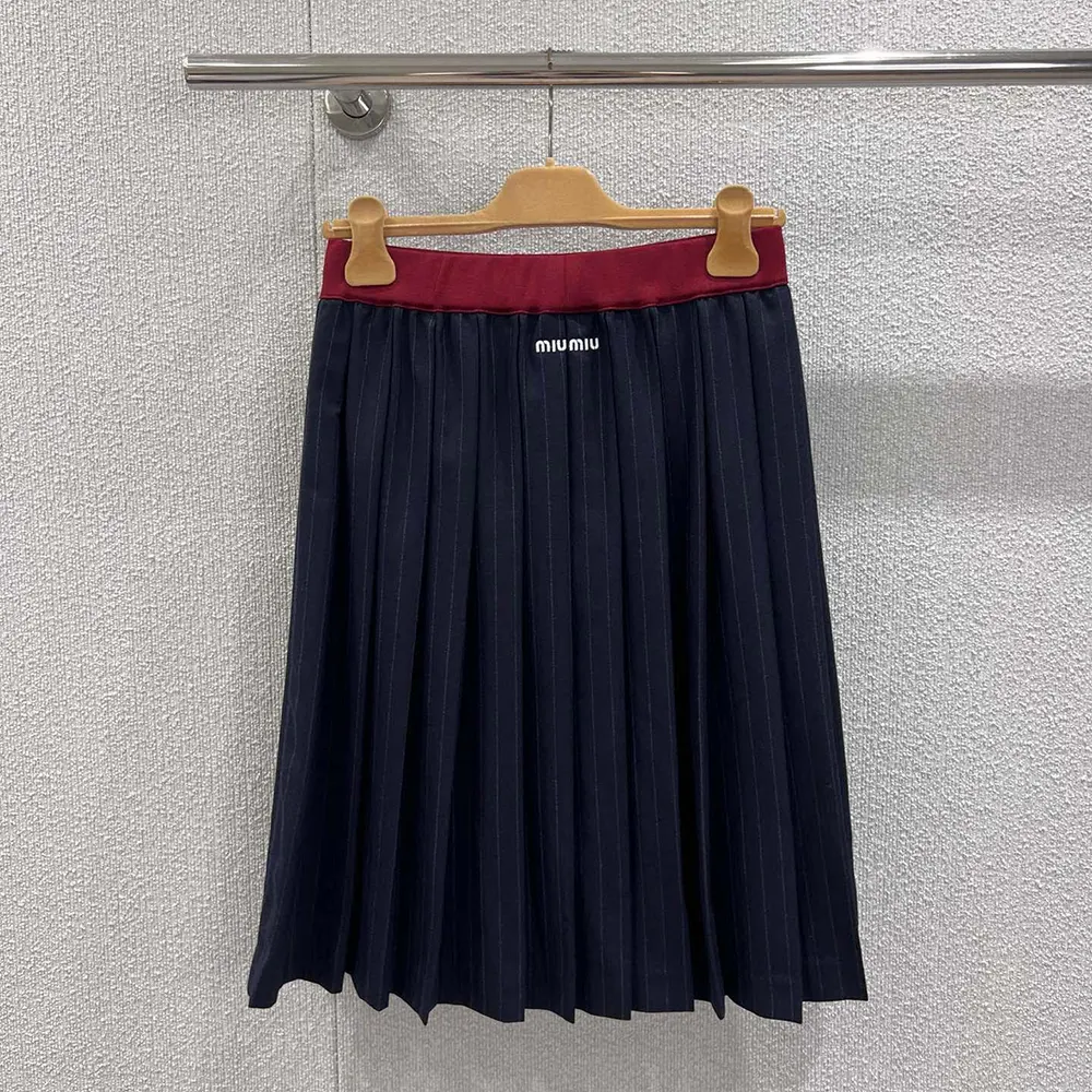 Close-up of pleated detail and pinstripe pattern on Miu Miu skirt